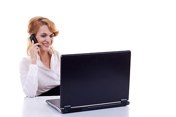 Image showing business woman using cell phone at desk 