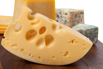 Image showing Different types of cheese on wooden table