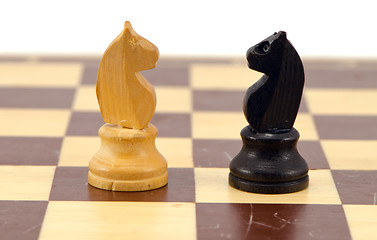 Image showing Gold crocodile nut crush tool on chess board 