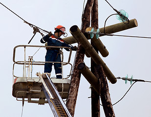 Image showing Electrician connects wires on the power line