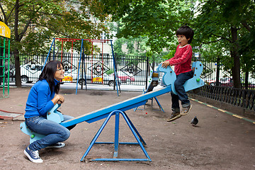 Image showing woman with a boy on a swing