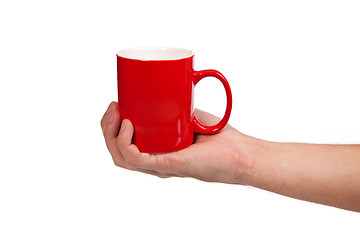 Image showing Male hand is holding a red cup