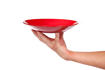 Image showing Red kitchen plate on a hand isolated