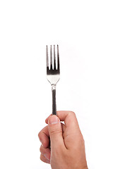 Image showing Right mans hand with empty metallic fork