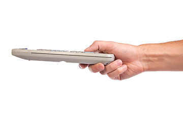 Image showing A hand holding a remote control isolated