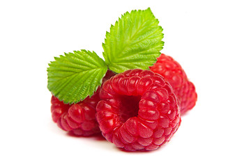 Image showing Ripe rasberry with green leaf isolated over white. Close up macr