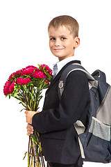 Image showing Schoolboy is holding flowers. Back to school