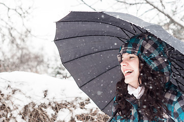 Image showing Girl with umbrella in the snow