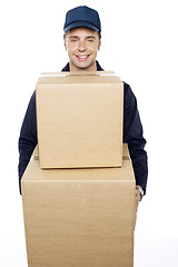 Image showing Young man carrying huge cardboard boxes