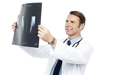 Image showing Experienced orthopedic surgeon reviewing x-ray report