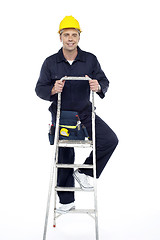 Image showing Its work time. Repairman climbing stepladder