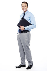 Image showing Handsome confident businessperson holding file folder