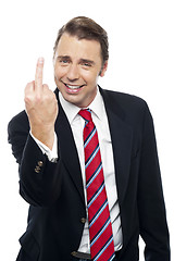 Image showing Displeased businessman showing middle finger politely