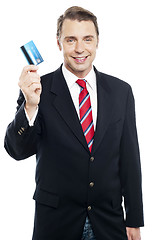 Image showing An entrepreneur showing debit card to camera