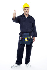 Image showing Young smiling industrial engineer showing thumbs up