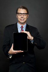 Image showing Portrait of businessman showing new digital device