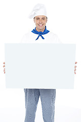 Image showing Handsome male chef holding ad board
