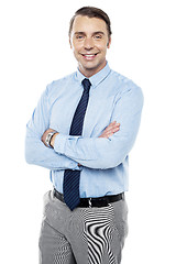 Image showing Smiling young team leader keeping his arms folded