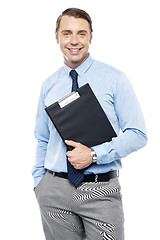 Image showing Handsome smiling executive holding clipboard