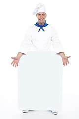 Image showing Chef holding blank billboard. Full length shot