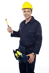 Image showing Repairman holding out hammer from his tool kit