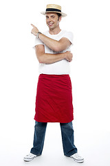 Image showing Man wearing a hat and apron pointing away