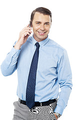 Image showing Business executive communicating over cellphone