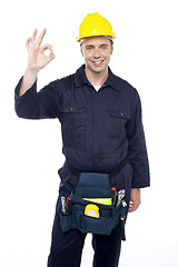 Image showing Senior repairman showing good work done sign