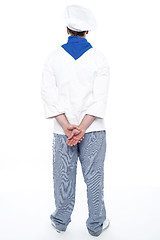 Image showing Rear view of male chef posing with hands behind