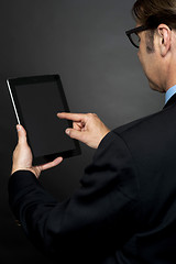 Image showing Rear view of boss browsing on new tablet pc