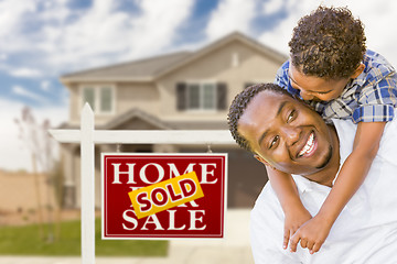 Image showing Mixed Race Father and Son In Front of Real Estate Sign and House