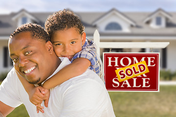 Image showing Mixed Race Father and Son In Front of Real Estate Sign and House