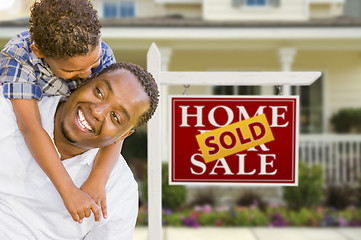 Image showing Mixed Race Father and Son In Front of Real Estate Sign and House