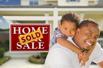 Image showing Mixed Race Father and Son In Front of Real Estate Sign and House