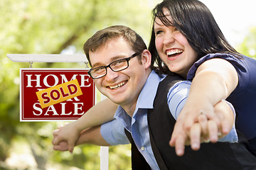 Image showing Happy Couple in Front of Sold Real Estate Sign