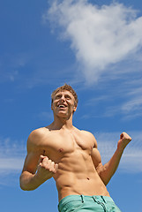 Image showing Fit smiling guy showing his strength