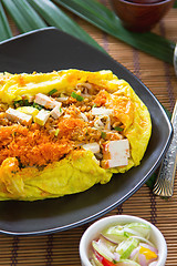 Image showing Stir fried vegetables and coconut wrapped in omelet [Thai's food]