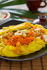 Image showing Stir fried vegetables and coconut wrapped in omelet [Thai's food]