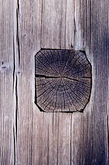 Image showing Ancient wooden house wall made of logs and planks. 