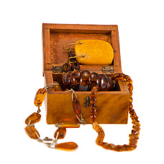 Image showing Amber jewelry in retro wooden box isolate on white 