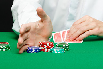 Image showing Man with cards on a gambling table