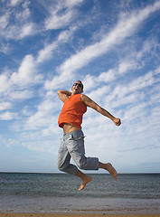 Image showing Young active man making a big jump