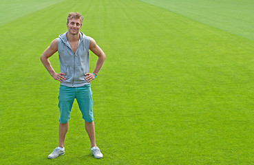 Image showing Sporty young man on green training field
