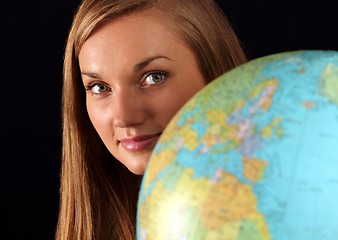 Image showing Woman behind globe