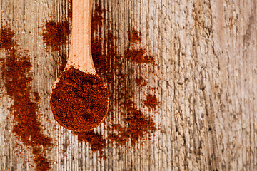 Image showing ground red pepper in wooden spoon