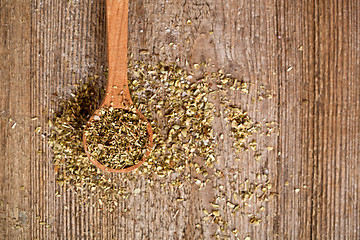 Image showing dry oregano in wooden spoon