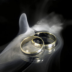 Image showing golden wedding rings and smoke