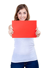 Image showing Beautiful girl with a red sheet of paper winks