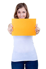 Image showing Beautiful girl with a yellow sheet of paper winks