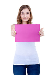 Image showing Beautiful girl with a pink sheet of paper winks